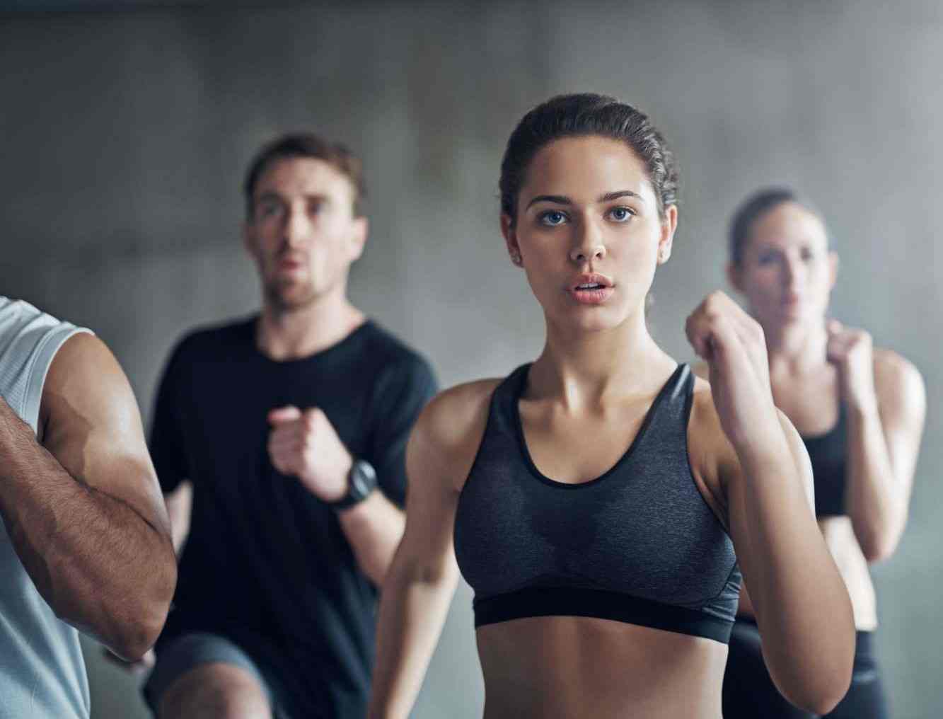 Fitness class going all out in a HIIT session. Fitness class going all out in a HIIT session.