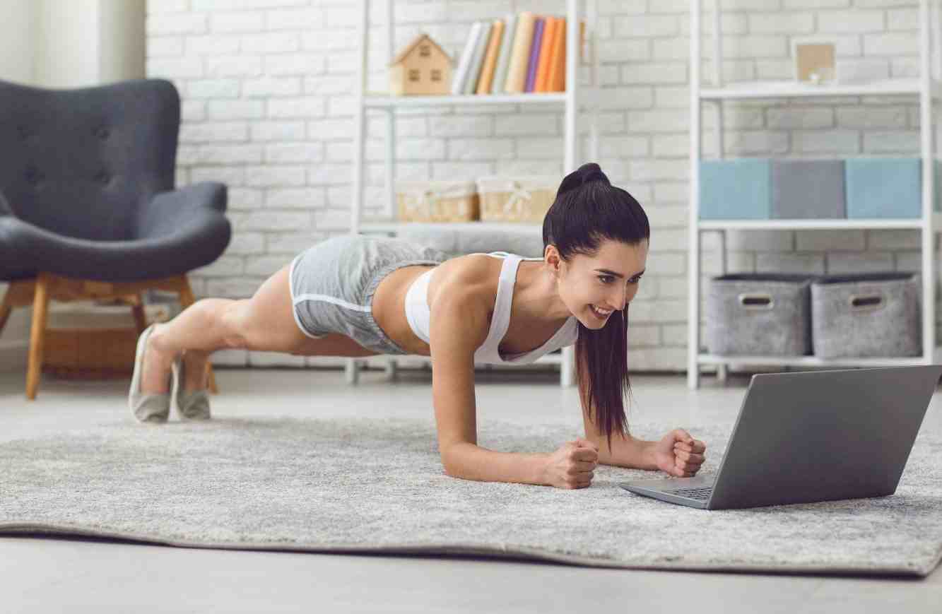 Person performing a plank exercise during a high-intensity interval training (HIIT) session, building core strength and aiding in weight loss.